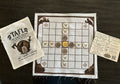 Tafl — The King's Escape game board, pieces, pouch, and rules card