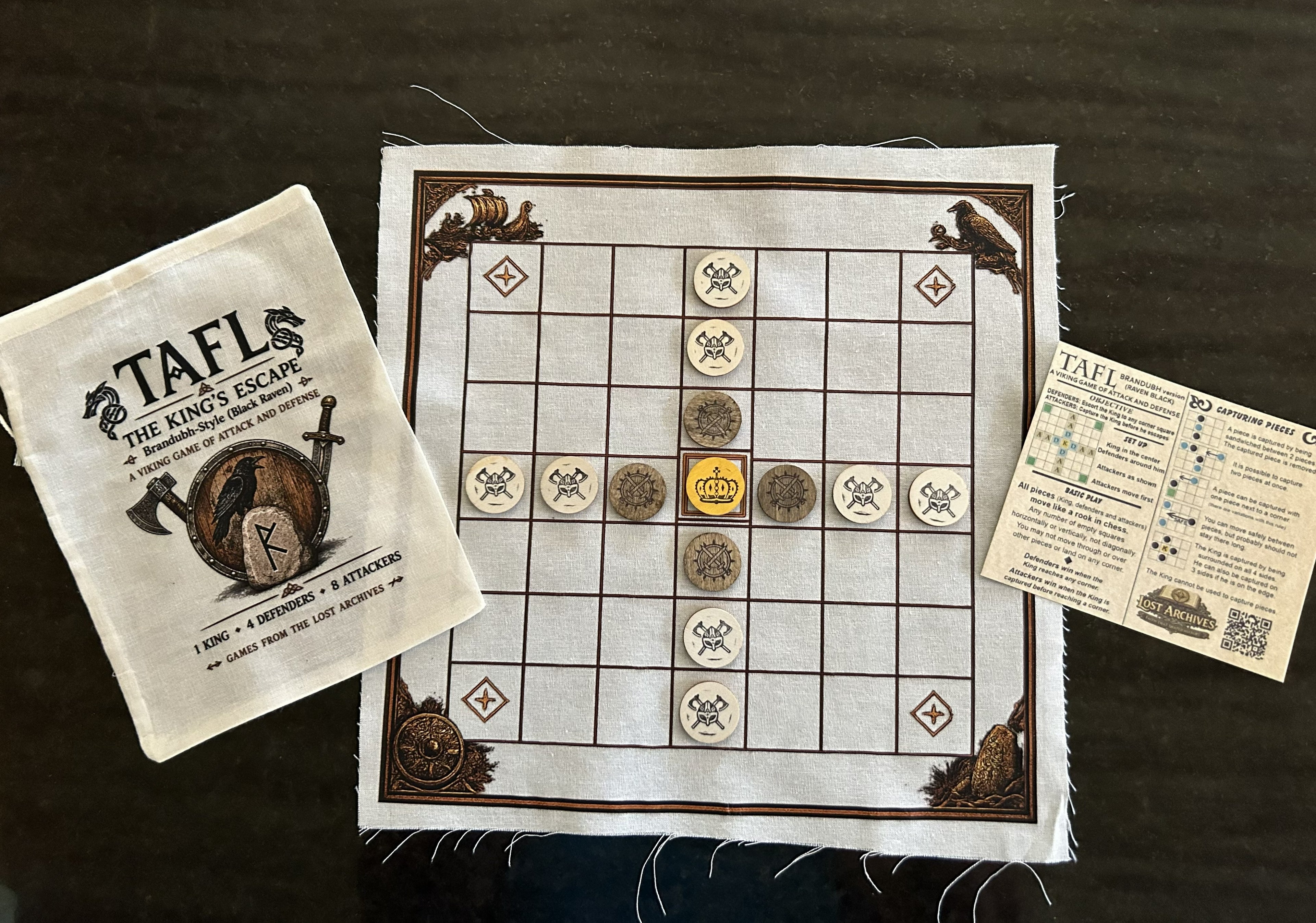 Tafl — The King's Escape game board, pieces, pouch, and rules card