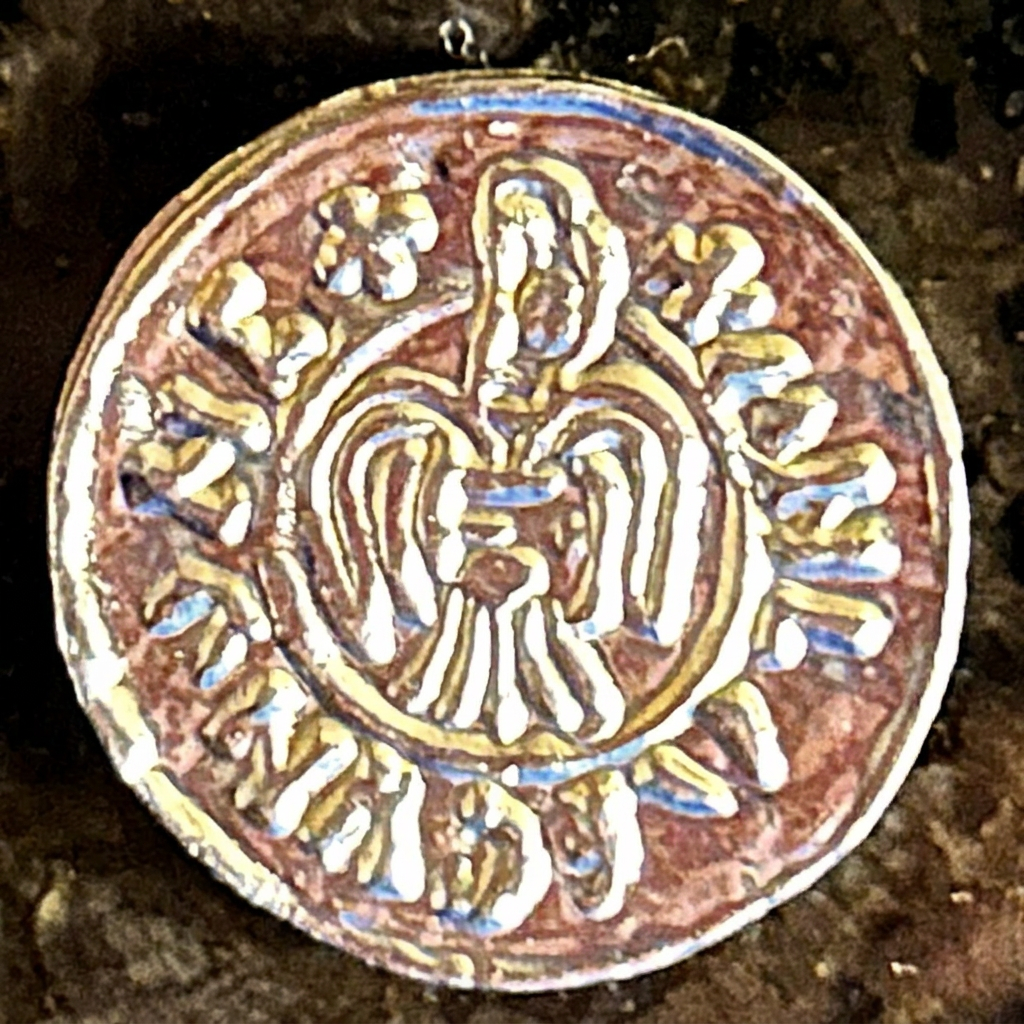 Raven on the front of a silver-colored Raven Penny replica