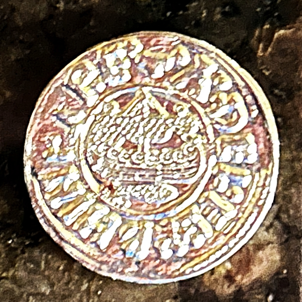 Ship on the reverse of a silver-colored Raven Penny replica
