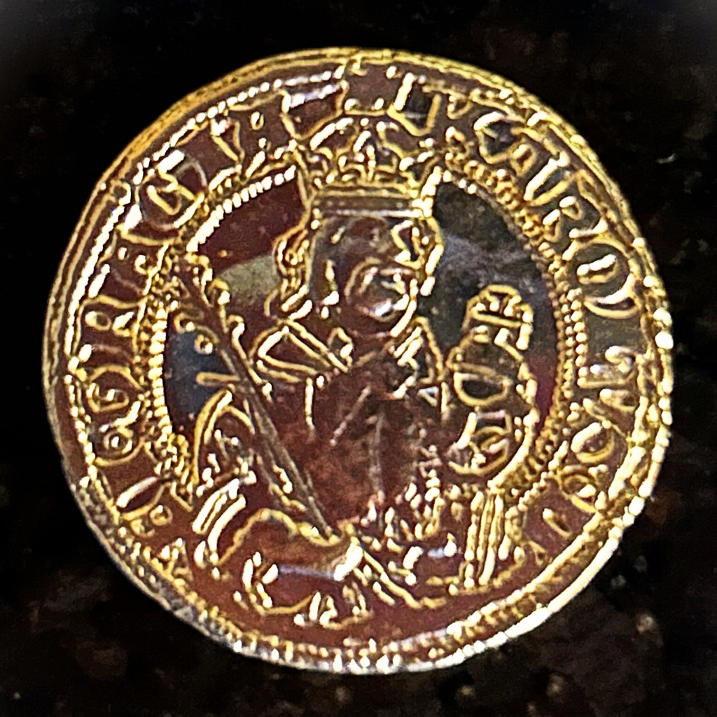 Crowned ruler holding a sceptre and orb on a gold-colored ducat replica